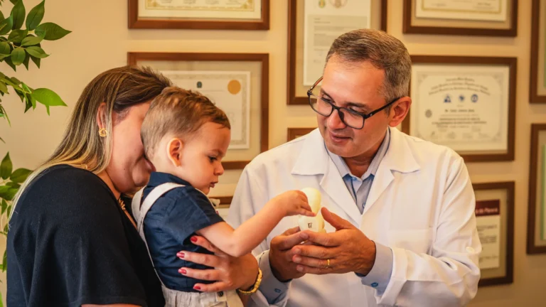 Dr. Rafael Bruns, especialista em medicina fetal, acolhe família durante consulta no consultório